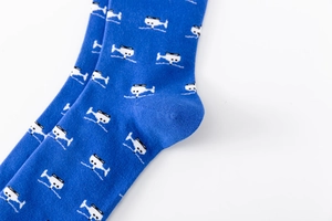 Close-up of royal blue cotton crew sock featuring a white pixelated helicopter pattern