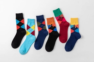 Detailed flat lay of six colorful argyle crew socks with unique fluid drip design