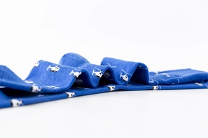 Close-up of royal blue cotton mid-calf socks featuring white helicopter embroidery patterns