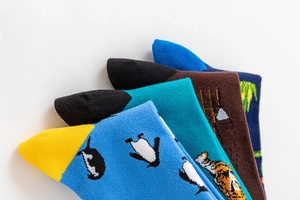Detailed view of colorful cotton socks with penguin, tiger and building patterns