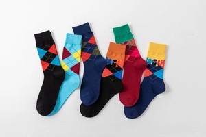 Detail of colorful argyle pattern socks with unique liquid drip design in combed cotton