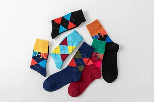 Detail of argyle pattern socks with unique fluid drip design and colorful knit texture