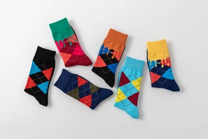 Flat lay of colorful cotton socks set featuring trendy argyle and drip liquid patterns