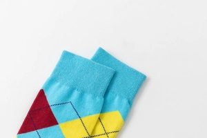 Close-up of argyle knit socks with ribbed cuffs in blue, burgundy and yellow