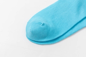 Detailed macro view of the seamless toe stitching on this sky blue cotton knit sock