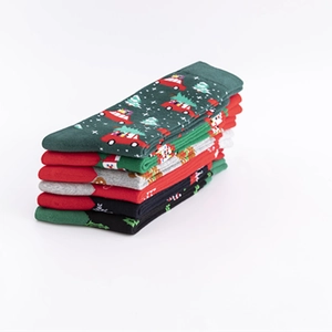 Set of six Christmas themed cotton crew socks with festive patterns on white background