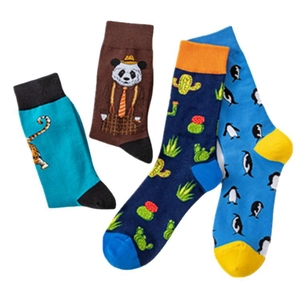 Set of four colorful patterned crew socks featuring tiger, panda, cactus and penguin motifs