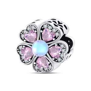 Macro detail of petal charm with pink heart zircons and moonstone on silver band