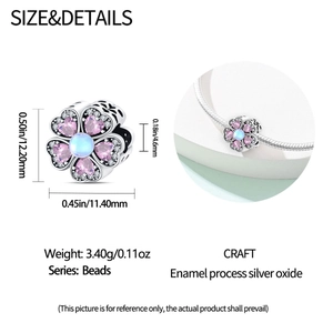 Macro detail of silver flower bead with pink heart petals and blue pearl core