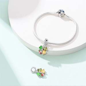 Detail of silver snake chain bracelet with clover pendant and colorful gemstones