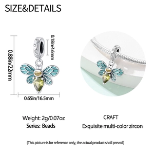 Detail view of a bee charm bead with green enamel wings and yellow zircons for bracelets