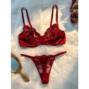 Elegant red lace lingerie set with floral embroidery and satin detailing on white mesh