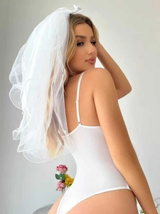 Detail of multi-layer white tulle bridal veil with elegant pearl edge and open back bodysuit