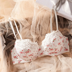 Detailed close-up of white floral lace bra with pink flowers and delicate adjustable straps