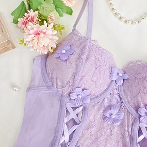Detail of purple lace bodysuit featuring 3D floral appliques and pearl decorations