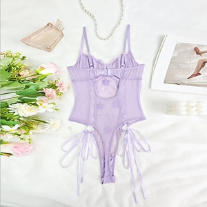 Flat lay of a lilac lace bodysuit with floral embroidery and delicate ribbon details