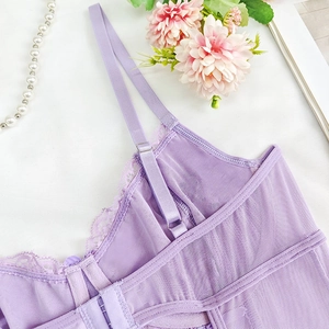 Detail of purple lace lingerie featuring adjustable straps and mesh fabric textures