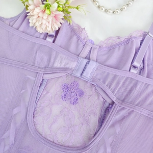 Detail of purple lace lingerie featuring adjustable straps and hook-and-eye back closure