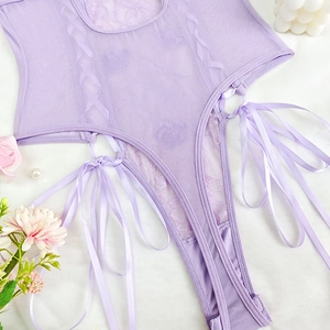 Detail of light purple lace and sheer mesh bodysuit with elegant satin side ribbon bows