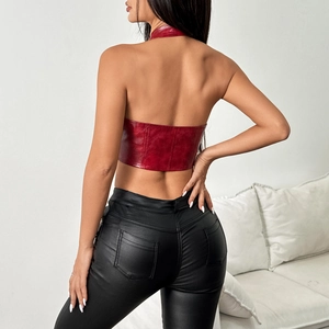Detail of red faux leather halter crop top and black skinny pants on a model from behind