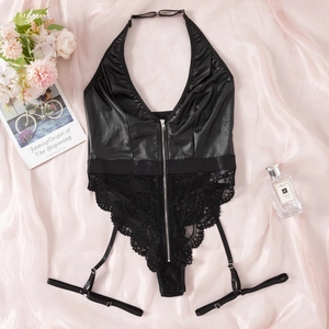 Flat lay detail of black faux leather teddy with lace trim, front zipper, and garters