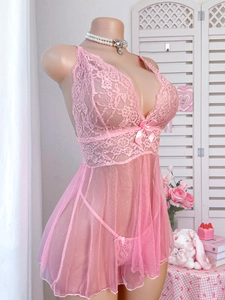 Detailed close-up of pink lace lingerie set featuring floral mesh and silk bow accents
