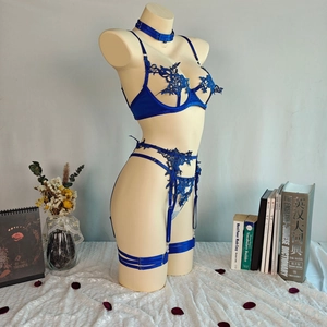 Detail of blue lace lingerie with floral embroidery and adjustable satin straps