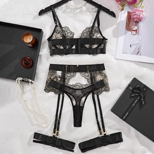 Detail of black lace lingerie set with geometric embroidery on white fabric