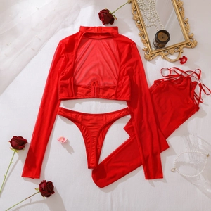 Red sheer mesh lingerie set with long sleeve top and lace accessories on white fabric