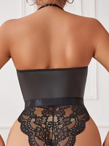 Close-up of black lace bodysuit featuring floral patterns and a T-back design