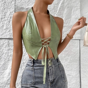 Close-up of green PU leather halter top with lace-up detail and deep V-neckline