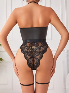 Detail of black lace bodysuit featuring back zipper closure and satin waist belt