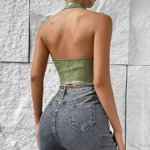 Back view of a green faux leather halter top showing slim fit and backless detail