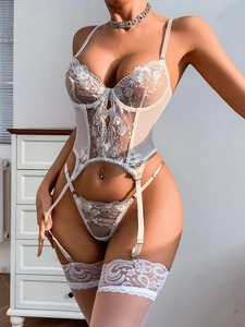 Detail of white floral embroidery on lace lingerie with supportive underwire structure