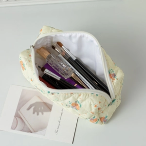 Macro detail of quilted floral makeup bag showing large capacity and soft fabric texture