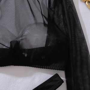 Detailed macro view of black sheer mesh fabric with fine wavy hem on the sexy lingerie top