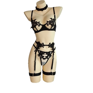 Exquisite black lace lingerie set with floral embroidery on white mannequin