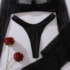 Flat lay of black sheer mesh sexy lingerie set with long sleeves and delicate thong details