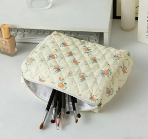Close-up of quilted floral makeup bag interior showing large storage capacity