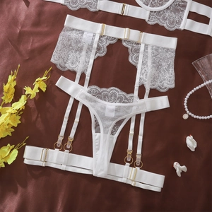 Detailed close-up of white lace garter belt set with adjustable straps and gold rings
