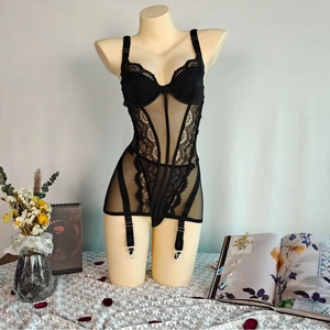 Detailed view of black lace and mesh corset bodysuit with adjustable garter straps