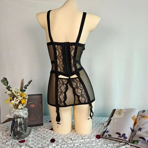 Detailed back view of lace bodysuit featuring mesh panels and adjustable garter clips