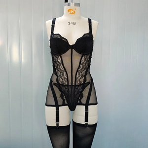 Detailed view of black lace corset lingerie set with sheer mesh and garter straps