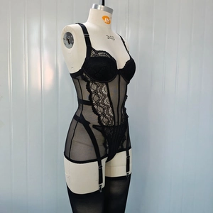 Close-up of black lace corset lingerie with mesh splicing and garter belt details