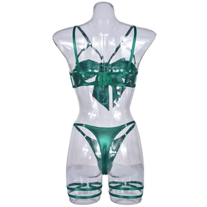 Detailed back view of dark green satin lingerie set with large bow and strappy details