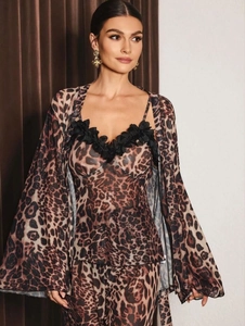 Detail of leopard print silk pajama set showing lace trim on camisole and matching robe