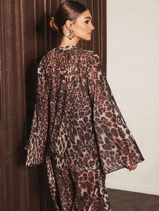 Detail of leopard print silk pajama set showing flowing texture and stylish pattern
