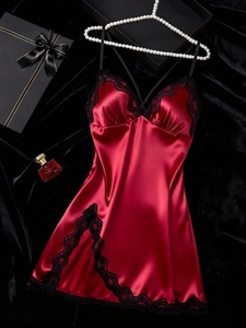 Close-up of wine red satin sleepwear with delicate black floral lace and silky texture