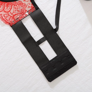 Close-up of red floral lace lingerie featuring black triple row hook-and-eye back closure