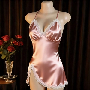 Detail of pink satin nightgown with white lace trim and elegant high side slit